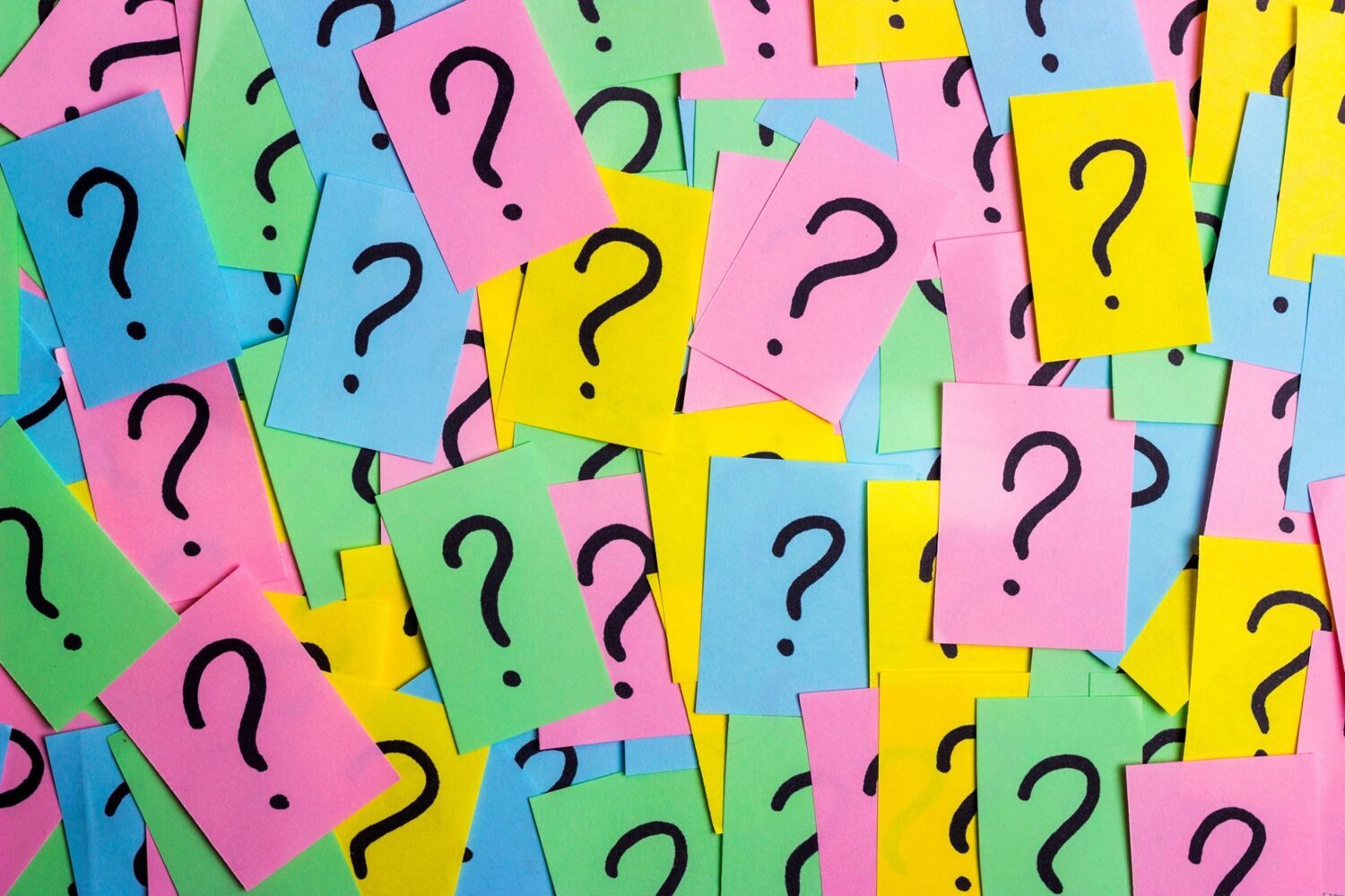 many question marks on multicoloured post-it notes